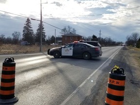 Ontario Provincial Police cruisers block Highway 2 at Switzerville Road in Napanee following a collision that killed a Napanee woman and sent another man to hospital. (Cris Vilela/For The Whig-Standard)