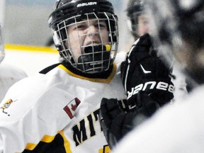 Connor Lockhart of the Mitchell Bantams celebrates his second period goal of Game 5 with teammates on the bench Sunday, March 11 in their OMHA B semi-final series with Penetang. ANDY BADER/MITCHELL ADVOCATE