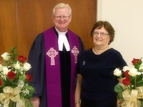 Rev. Robert Adams (left), of Knox Presbyterian Church in Mitchell, poses with Audrey Vorstenbosch during a brief ceremony March 4, recognizing Vorstenbosch’s 40 years of musical involvement with the church. SUBMITTED