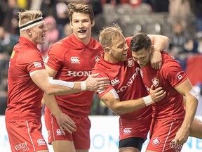 Belleville's Matt Mullins (second from left) celebrates a try with Canadian teammates at the Vancouver event of the 2017-18 HSBC World Rugby Sevens Series last weekend at BC Place. (Rugby Canada photo)