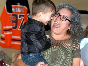 Tucker Marcolin and his mom Trina Marcolin share a smile during a fundraiser held at the Wallaceburg Moose Lodge on March 10. The fundraiser was to help with Tucker's future medical needs, as he was attacked by a pair of dogs at last month. David Gough/Postmedia Network