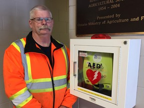 West Elgin Fire Chief Jeff Slater is seen beside the automated external defibrillator (AED) located inside the Rodney Community Centre. The Municipality of West Elgin wants more people to become familiar with the use of the life saving device after council learned residents still have misconceptions about AEDs. Vicki Gough/Special to Postmedia Network