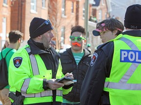 Kingston Police issued liquor licence infractions during St. Patrick’s Day on Aberdeen Street on March 17, 2017. (Steph Crosier/The Whig-Standard)