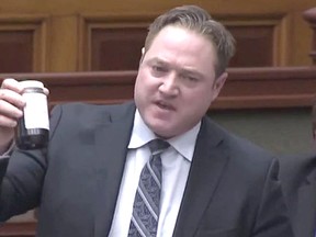 Essex MPP Taras Natyshak holds up a sample jar of Chatham-Kent well water in Queen's Park on March 8. Taras Natyshak/Facebook