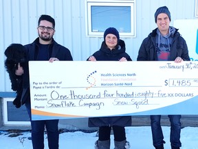 Bello the dog, Mitch Gammon, left, general manager of Snow Squad, Sally Dunton, manager of community engagement at the HSN Foundation, and Taylor Marshall, owner of Snow Squad, take part in a cheque presentation. Supplied photo