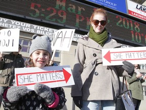 Jessica Rouleau and her daughter Audrey Gignac take part in the She Matters demonstration outside the Sudbury Community Arena before the Hedley concert on Wednesday. Gino Donato/Sudbury Star/Postmedia Network