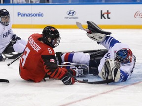 Canada's Tyler Mcgregor of Forest, Ont., is blocked by South Korea's goalie Lee Jae-woong during a para hockey semifinal at the 2018 Winter Paralympics in Gangneung, South Korea, on Thursday, March 15, 2018. (LEE JIN-MAN/The Associated Press)