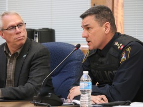 BRUCE BELL/THE INTELLIGENCER
Belleville police chief Ron Gignac discusses the 2017 policing budget with police services board member Jack Miller at Thursday’s regular meeting. Gignac will present the $17.7-million budget during deliberations in April.
