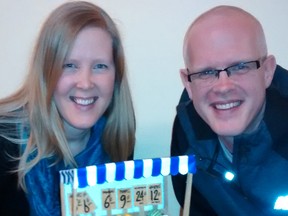 Sarah and David Van Pelt and the miniature fruit peddlar’s pushcart she was inspired to create as he shared research for his newly published book about New York youth gangs of the 1950s. (Eric Bunnell // Special to the Times-Journal)