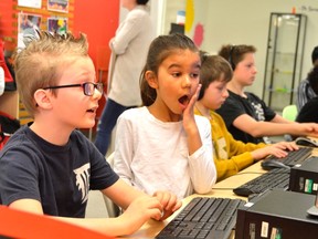 Bentley Hudson, left, and Olivia Bernardo, right, take advantage of the computers at the St. Thomas Public Library during their March Break on Thursday. The library is quickly developing into a hub for all things literacy -- everything from written to technological. (Louis Pin/Times-Journal)
