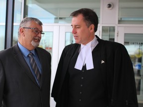 Former Sarnia fire chief Patrick Cayen, left, talks with his lawyer Phillip Millar after being acquitted of 24 sexual offences. (NEIL BOWEN/Postmedia Network)