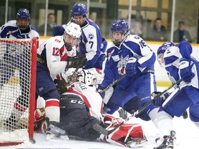Members of the Sudbury Nickel Capital Wolves scramble for the puck in front of goalie North Bay Midget Trappers Joel Rainville  during Great North Midget League playoff action in Sudbury, Ont. on Sunday March 11, 2018. Gino Donato/Sudbury Star/Postmedia Network