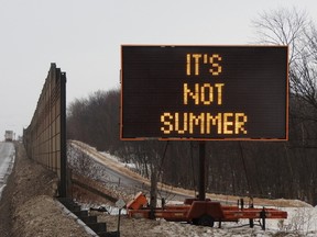 The Ministry of Transport helpfully tells motorists on the 401 that "it's not summer." Wayne Lowrie/Postmedia Network