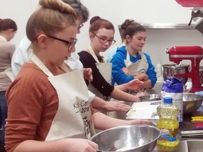 Jenna Yaremchuk Olivia Millier and Kalara Fradette work on their team’s carrot and zucchini cake with cream cheese icing. - Photo by Josh Thomas