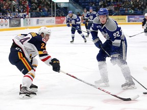 Blake Murray, right, of the Sudbury Wolves, attempts to get by TJ Fergus, of the Barrie Colts, during OHL action at the Sudbury Community Arena in Sudbury, Ont. on Friday March 16, 2018. John Lappa/Sudbury Star/Postmedia Network