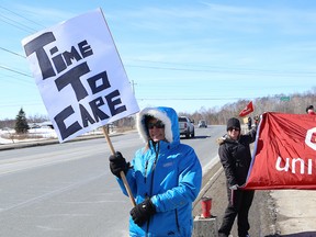 Members of Mine Mill Local 598/Unifor and supporters hold a rally near the Elizabeth Centre in Val Caron on Friday. The demonstration was held to draw attention to the need for minimum care standards for residents in long-term care facilities. John Lappa/Sudbury Star/Postmedia Network