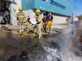 Race to Erase participants douse water on an imaginary fire during the 2013 competition. This year's Race to Erase takes place May 12, pitting participants against challenges and spotlighting community organizations. (File photo)