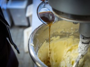 Prepare to shell out a little more for the sweet treats of spring and summer as a global surge in the price of vanilla makes its impact at some small-batch ice cream shops and neighbourhood bakeries. A baker at Dlish Cupcakes, a bakery that uses vanilla every day, prepares the day's first batch in Toronto on Saturday, March 17, 2018. THE CANADIAN PRESS/Chris Donovan