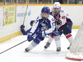 Ian Denomme of the North Bay Trappers battles for the puck with Carson McMillan of the Sudbury Nickel Capital Wolves during Great North Midget League championship game action in Sudbury, Ont. on Sunday March 18, 2018. The Wolves won in overtime to capture the Great North Midget League championship.Gino Donato/Sudbury Star/Postmedia Network