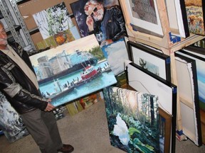 Paint Ontario judge and founder Barry Richman is shown with some of this year's record number of entries. The show opens Friday at the Lambton Heritage Museum near Grand Bend. (Handout/The Observer)