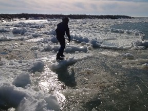 Shane Hesch taking a stroll on the icebergs on Lake Huron, prior to slipping into the water for an exploration of the bottom of the lake. (Courtesy of Shane Hesch)