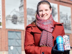 Elizabeth Nagy holds a pair of craft beers in front of the Elgin County Railway Museum, the venue of the first ever "Beer-lesque and Carniv-ale" in St. Thomas. The drinks were produced by a pair of nearby craft brewers, both which will be featured in the upcoming event. (Louis Pin/Times-Journal)