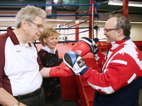 Chris Sheridan and Estelle Joliat work the pads with boxing coach Gord Apolloni in Sudbury, Ont. on Tuesday March 20, 2018. Gino Donato/Sudbury Star/Postmedia Network