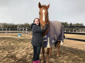 Brenna Parkhill with Diamond Beau, a horse rescued from being slaughtered, raised money with other students to save the former racehorse. (Submitted photo)