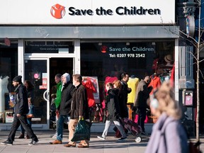 People walk past a high street branch of a Save the Children charity shop in south London on February 17, 2018.  / AFP PHOTO / Justin TALLISJUSTIN TALLIS/AFP/Getty Images