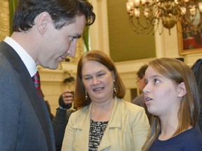 Toronto cancer survivor Helena Kirk, then 11, uses a planned March 20, 2017 photo shoot with Prime Minister Justin Trudeau in Ottawa to tell him of the need for more funding for childhood cancer research and access to clinical trials for young patients. With them was then-Health Minister Jane Philpott. Local families now affiliated with her Helena's Hope campaign met recently with Bay of Quinte MP Neil Ellis to make similar pleas. Sarah Calderwood photo