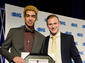 Quinton Byfield, left, accepts his OMHA ETA minor midget player of the year award at the OHL Cup banquet last week. OHL Images