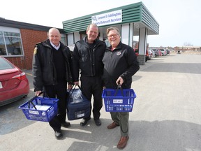 Greater Napanee Fire Services Deputy Fire Chief John Koenig, fire public educator Randy Cook and Napanee Mayor Gord Schermerhorn assist with delivering Meals on Wheels on Wednesday. (Meghan Balogh/The Whig-Standard)