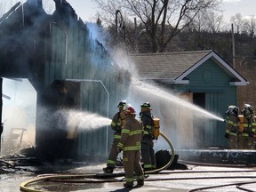 Prince Edward County firefighters battle a blaze at a garage on County Road 3 in the Village of Rednersville Thursday afternoon. The fire destroyed the garage and caused damage to a neighbouring shed. The cause of the fire remains under investigation, fire officials at the scene stated.