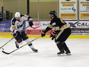 Tyler Maltby works his way around Generals defenceman and captain Don Morrison. 
Photo by Josh Thomas.