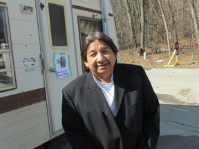 Maynard T. George is shown standing Tuesday outside a trailer he and other aboriginal protesters set up this week at the entrance to Pinery Provincial Park. The protesters say the park is part of a tract of land never property surrendered by their ancestors. (File photo)