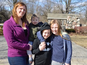 Samantha Lesser, left, stands in the Cancer Survivors Garden in London, Ontario with her children Graham (held), Sophia (middle), and Grace (right). Lesser was diagnosed with Hodgkin's lymphoma in 2012 but was successfully cleared before the end of the year. During that time she relied on the Canadian Cancer Society, which relies on donations during their Daffodil Month every April. (Louis Pin/Times-Journal)