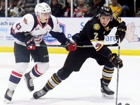 Sarnia Sting's Theo Calvas (2) is chased by Windsor Spitfires' Louka Henault (43) during Game 1 in their OHL Western Conference quarter-final at Progressive Auto Sales Arena in Sarnia, Ont., on Saturday, March 24, 2018. (MARK MALONE/Postmedia Network)