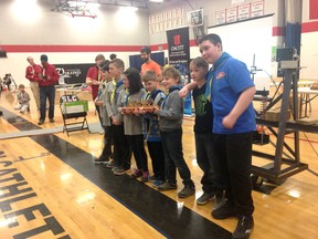 Kingston Scouts hold the first-place trophy for their winning bridge design, which was tested under pressure to see how much load it could bear at the Bridge the Engineering Gap event at St. Lawrence College in Kingston on Saturday.