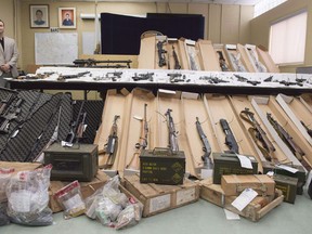 Longueuil police display seized firearms during a news conference in 2016. (Canadian Press file photo)