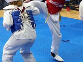 Eleven-year-old Emma Lebelle (right) delivers a roundhouse kick during a Michigan taekwondo competition where she eventually took gold.
Handout/Sarnia This Week