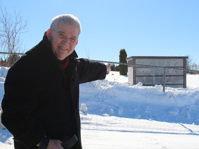 Councillor Claude Bourassa, chairman of the Cemetery Committee, points to his choice of niche in the Town's newly delivered columbarium. The niches will go on sale shortly and provide residents an alternative to a regular plot.