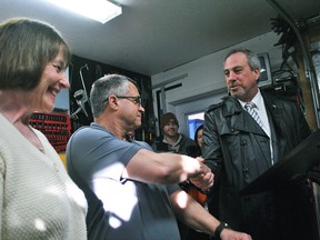 Chatham-Kent Mayor Randy Hope, right, congratulates Dianne and Dan Stewart on Trim King's distinction as Feature Industry of the Month for March at the Freeland Avenue business on March 23. (Tom Morrison/Chatham This Week)