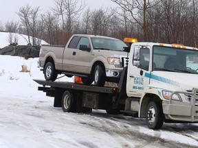 A pickup truck is removed from the site where a body was recovered off the Highway 144 extension between Chelmsford and Lively on Tuesday. (John Lappa/Sudbury Star)