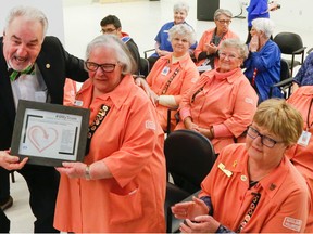 Luke Hendry/The Intelligencer 
Quinte Health Care chairman Stuart Wright presents a certificate appreciation to members of the Belleville General Hospital Auxiliary Tuesday. This is the auxiliary's 80th year and anniversary co-ordinator Selma Bochnek, front centre, accepted the certificate with auxiliary president Leah Johnson, front right.