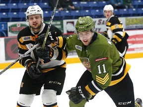 Daniel Walker, right, of the North Bay Battalion, and Liam Murray, of the Kingston Frontenacs, battle for position during OHL playoff action at the Sudbury Community Arena in Sudbury, Ont. on Tuesday March 27, 2018. John Lappa/Sudbury Star/Postmedia Network