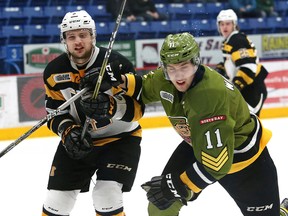Daniel Walker, right, of the North Bay Battalion, and Liam Murray, of the Kingston Frontenacs, battle for position during Ontario Hockey League playoff action at the Sudbury Community Arena in Sudbury on Tuesday. (John Lappa/Postmedia Network)