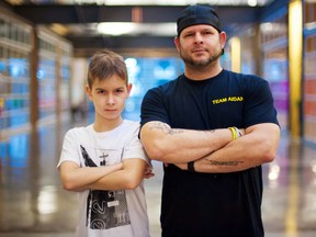 Ali Eisner Photography/Childhood Cancer Canada
Belleville's Aidan Reil, who has brain cancer, stands with his father, Wayne Reil. Wayne said he's tired of governments and politicians talking about past investments each time he calls for more childhood cancer research.