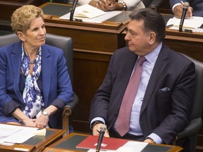 Ontario Premier Kathleen Wynne and Provincial Finance Minister Charles Sousa attend the Throne Speech at the Ontario Legislature in Toronto on Monday, March 19, 2018. THE CANADIAN PRESS/Chris Young