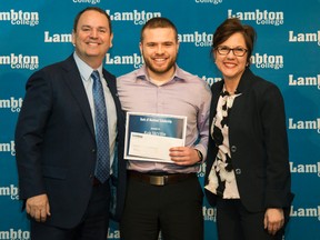 Lambton College student Kyle McVittie poses with Bank of Montreal regional vice-president Bob Ferris, and college vice-president Donna Church after receiving one of the college's 157 academic awards earlier this week. More than 100 students received awards. (Handout)
