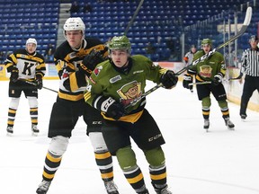 Brad Chenier, right, of the North Bay Battalion, battles for position during OHL playoff action against the Kingston Frontenacs at the Sudbury Community Arena in Sudbury on Tuesday. (John Lappa/Postmedia Network)